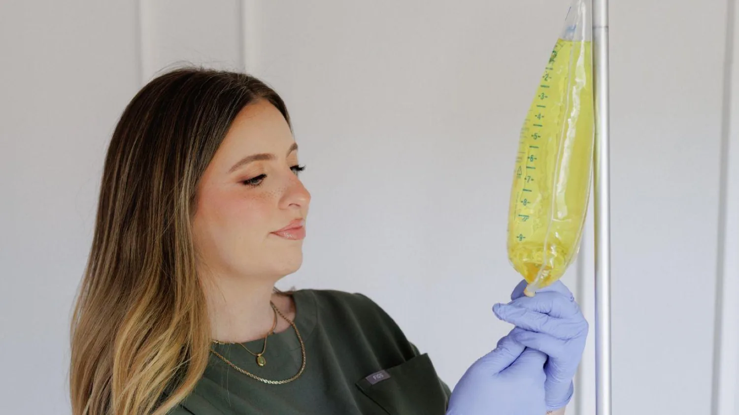A Hydration Company nurse preparing a vitamin IV drip bag